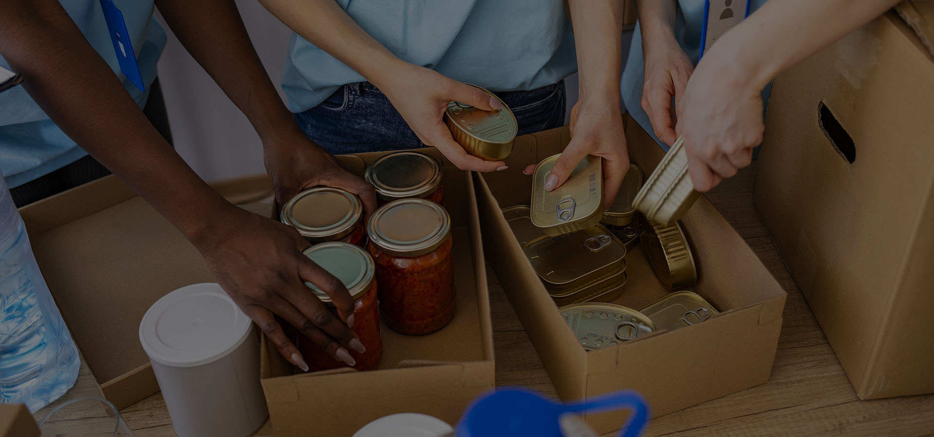 Stock image of tinned food being placed in boxes